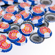 Product Image - Bottle Crowns - un-crimped bottle caps scattered in image frame.